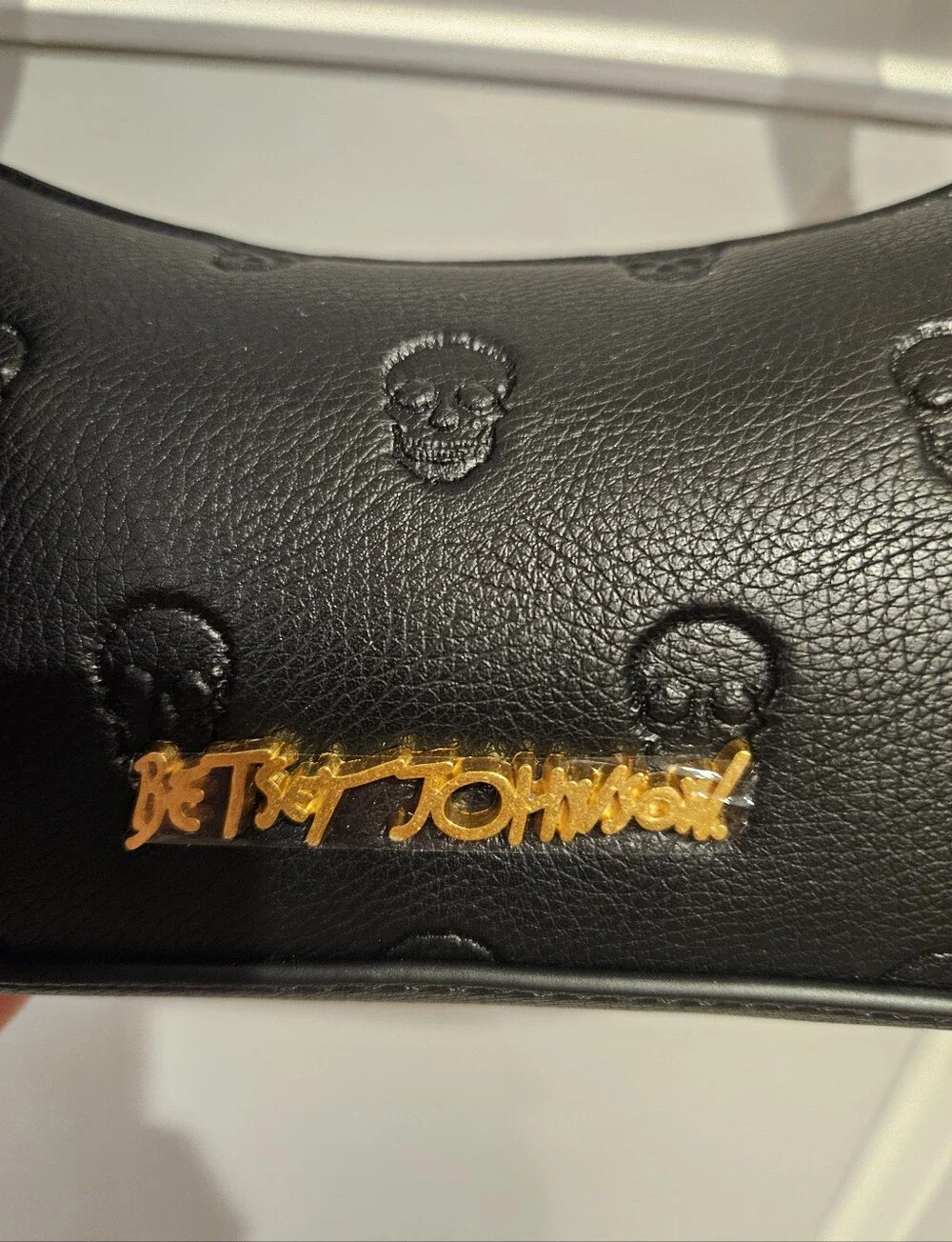 Betsey Johnson Black Leather Shoulder Bag with Skull Emboss and Scarf Accent